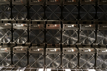Bitcoin ASIC miners in warehouse. ASIC mining equipment on stand racks for mining cryptocurrency in steel container. Blockchain techology application specific integrated circuit units storage. - obrazy, fototapety, plakaty
