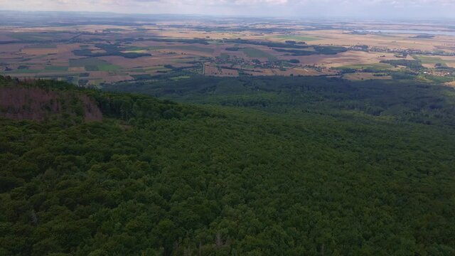 Drone flight over mountain village with forests. Sleza mountain near Wroclaw in Poland. Nature background, aerial view
