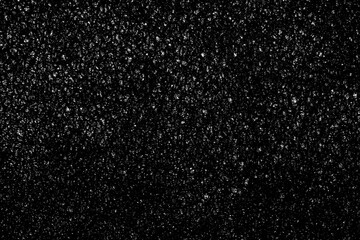 Obraz premium Falling snow on a black background. small particles with bright dots starry sky. Сhaotic white bokeh. light spots texture. abstract.