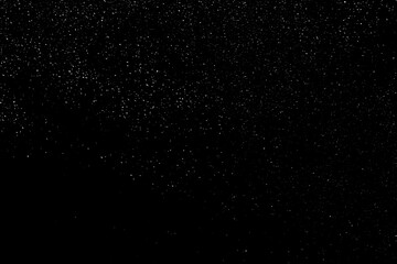 Falling snow on a black background. small particles with bright dots starry sky. Сhaotic white bokeh. light spots texture. abstract.