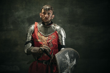 Portrait of one brutal bearded man, medeival warrior or knight with dirty wounded face