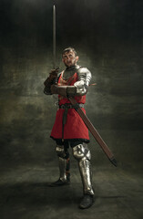 Full length portrait of one brutal bearded man, medeival warrior or knight with dirty wounded face