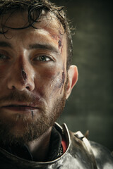 Portrait of one brutal bearded man, medeival warrior or knight with dirty wounded face