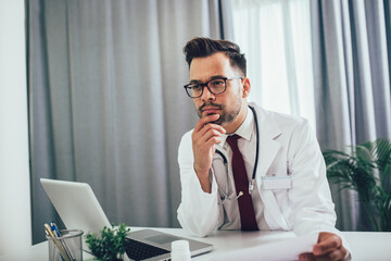 Young doctor working with computer in office