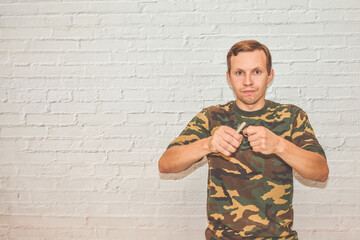 the young man with a hand grenade on a white background