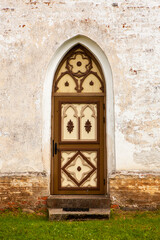 Old wooden church door. Wooden beautifully colored and decorated old door. 