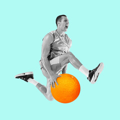 Fit young man jumping with huge orange on blue background. Male basketball player with orange fruit as ball. Healthy eating concept.