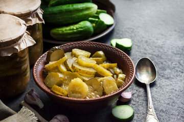 Pickled cucumber salad in a bowl and jars