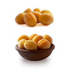 Fototapeta na wymiar Heap of apricots isolated on white background. Ripe apricots with copy space for text. Apricots in a wooden bowl on white background. Fresh summer fruits. Set of apricots.