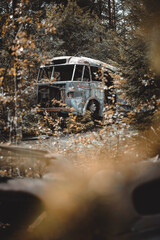 Old abandoned bus deep in a forest. Selective focus.