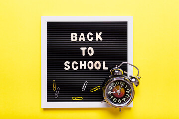 Stationary concept, Flat Lay top view Photo of school items, pencils, paper clips,stapler  on yellow background with copy space..