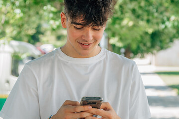 Fototapeta na wymiar teenage boy with mobile phone on the street