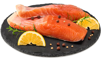 Red fish. Raw salmon fillet with rosemary, peppercorns and lemon on black round stone plate isolate on white background. Clipping path and full depth of field