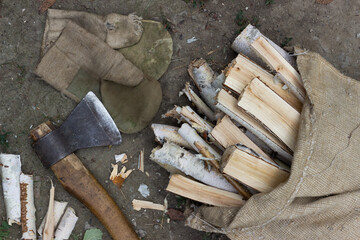 Axe and bag with firewood. Harvesting of firewood 
