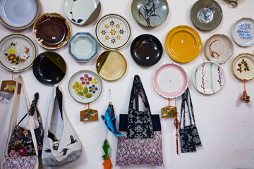 Bags and dishes hang on the wall