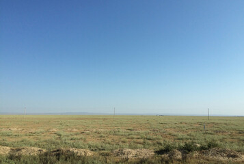 The vast steppe landscape of Kyrgyzstan on a sunny day