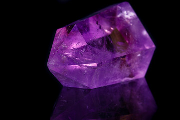 Macro mineral stone Amethyst crystal on a black background