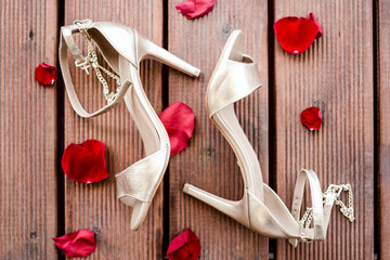 Golden high heel shoes with rose petals