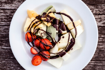 Delicious fruit salad with chocolate topping