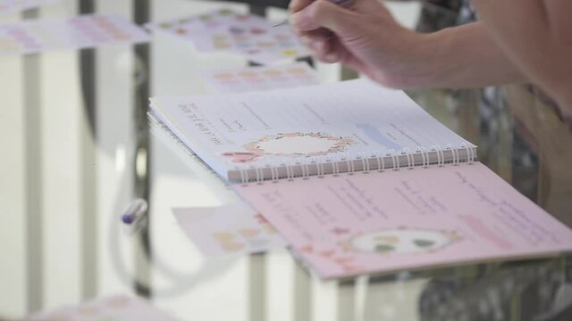 hand with pen writing in notebook wedding memories and congratulations