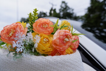 The cool background of the journey has a sky, trees with beautiful flowers and a white hat on the windshield.