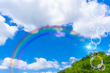 太陽の日差しと虹がかかった青空と雲の背景素材_b_29