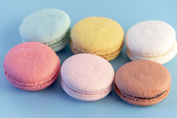 Sweet french macaroons cake pastel colored or macarons with vintage pastel blue colored background