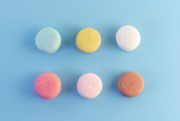 Sweet french macaroons cake pastel colored or macarons with vintage pastel blue colored background