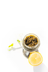 Appetizers of natural sturgeon black caviar, lemon and parsley