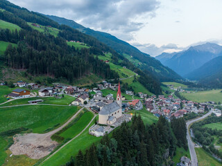 Fototapeta premium Austrian church seen from the side with lake and valley behind