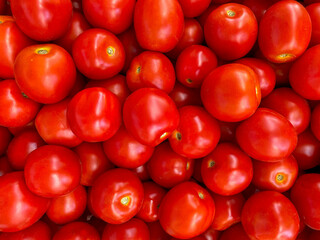 Background of beautiful and red tomatoes. Beautiful and large background and view of a large number of red beautiful and ripe tomatoes.
