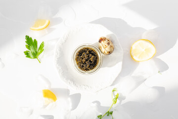 Appetizers of natural sturgeon black caviar, lemon and parsley
