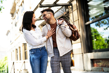 Happy young couple outdoors. Loving boyfriend and girlfriend walking in the city.