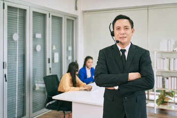 Fototapeta premium Asian business male call center presenter for service information provider to support customer issue