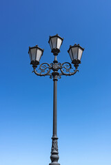 Fototapeta na wymiar Metal street light on blue sky background