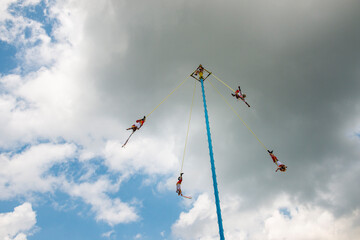 A group of voladores (flyers) performing the traditional Danza de los Voladores (Dance of the Flyers) in Papantla, Mexico.