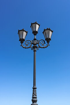 Metal street light on blue sky background