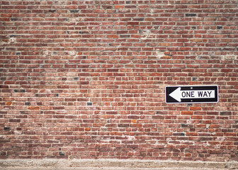 Brick Wall with One Way Sign