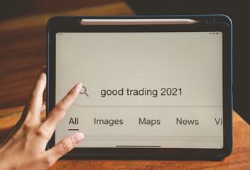 hand typing for searching about good trading in 2021 for being advice in investment of people