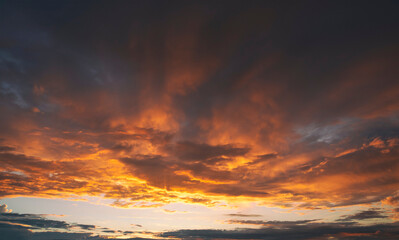 Fototapeta na wymiar The beautiful sunset in the sky and lots of big dark clouds