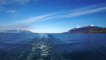 the ship leaves against the backdrop of snowy mountains and the horizon at sea, Akureyri, Iceland
