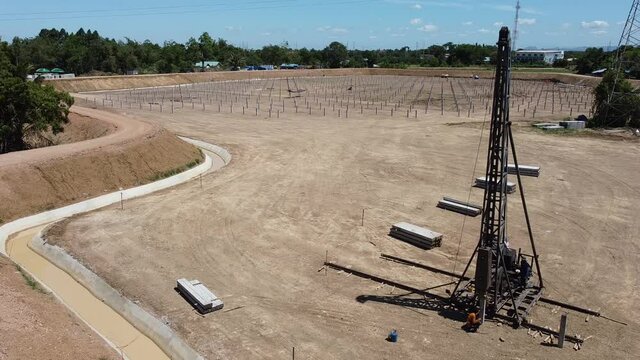 pile rig Equipment for installing piles in ground prepare for  solar farm, heavy machines for driving pillars work in laying the foundation building. Construction aerial view height from drone.