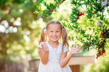 little girl catches soap bubbles in the park