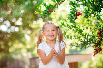 little girl catches soap bubbles in the park