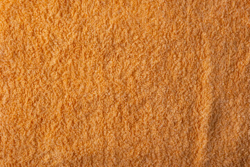texture of orange towel close up, top view
