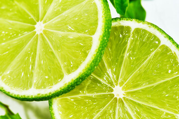 Close-up of top the slices of lime on white. macro shot. preparing cocktails, summer lemonade.
