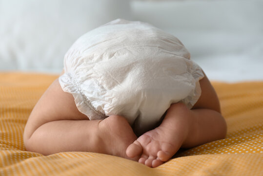 Cute Little Baby In Diaper On Yellow Blanket