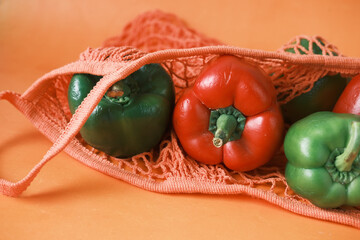 red and green color capsicum in a reusable shopping bag 