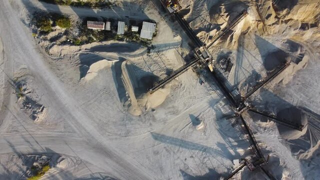 Aerial view of the limestone quarry with machinery and conveyor.