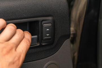 Close-up of a man's hand opens the car door from the inside, copy the space